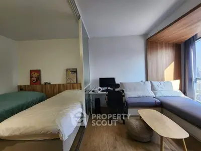 Modern studio apartment with cozy living area and city view