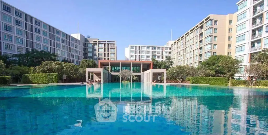 Luxurious residential complex with stunning pool and modern architecture.