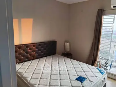 Cozy bedroom with large window and modern decor, perfect for relaxation and comfort.