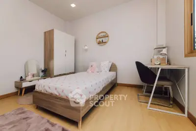 Charming bedroom with cozy decor and natural light, perfect for relaxation and comfort.