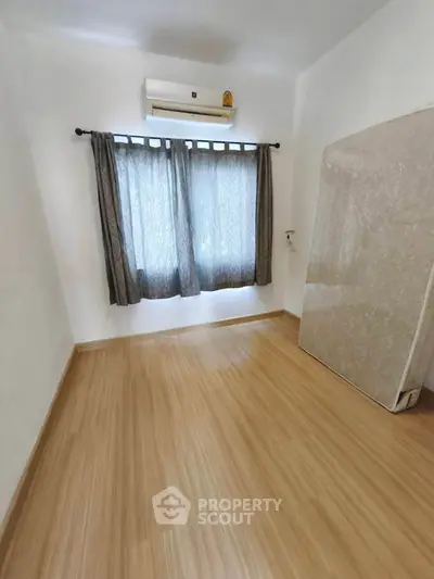Spacious unfurnished bedroom with air conditioning and natural light