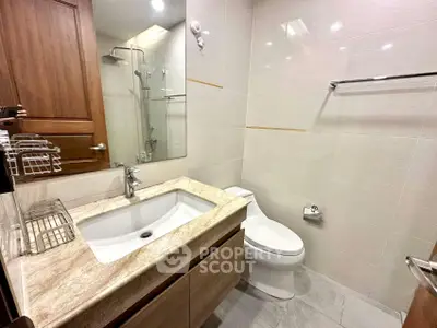 Modern bathroom with sleek fixtures and elegant marble countertop in a stylish apartment.