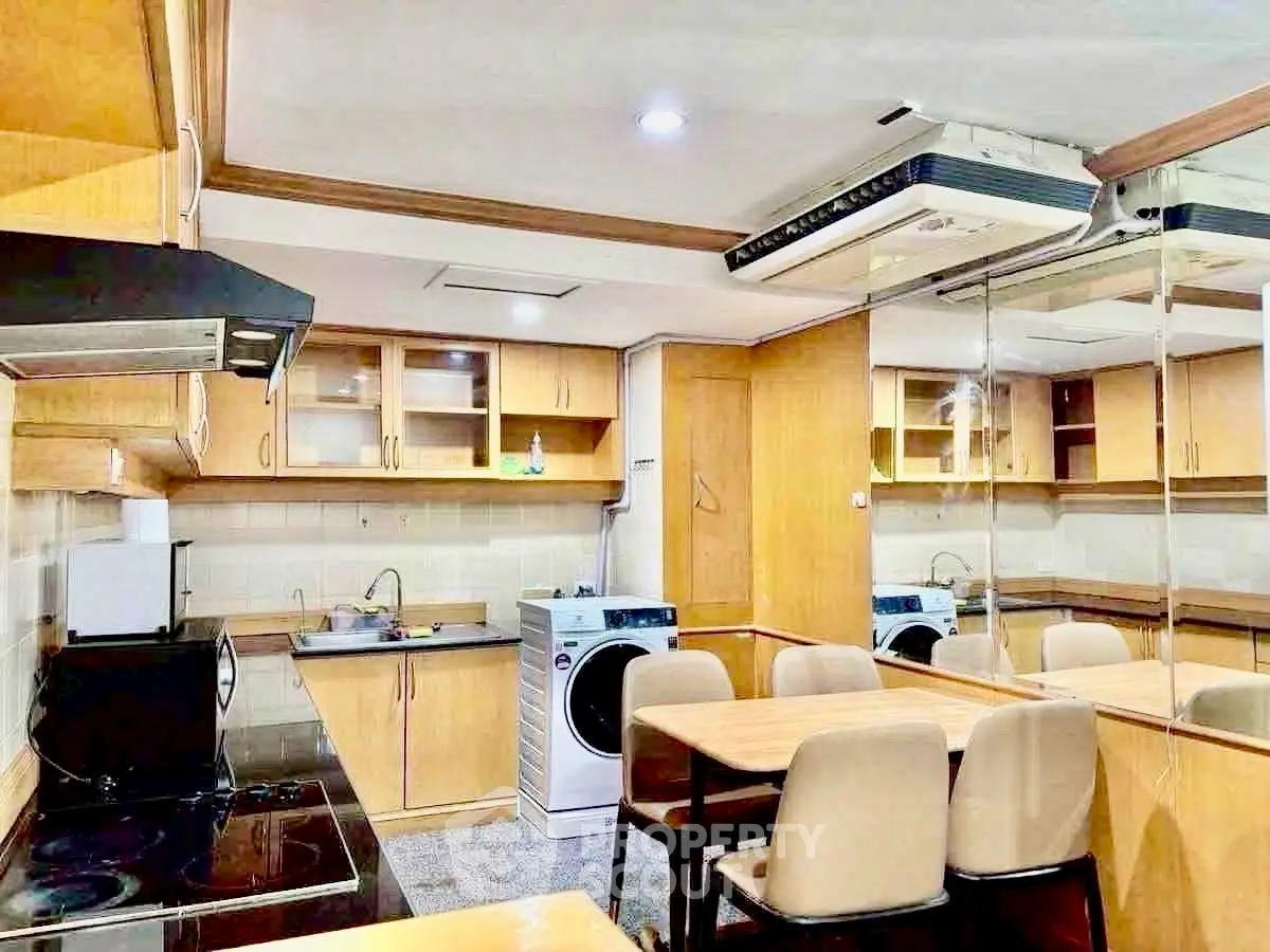 Spacious kitchen with modern appliances and wooden cabinetry