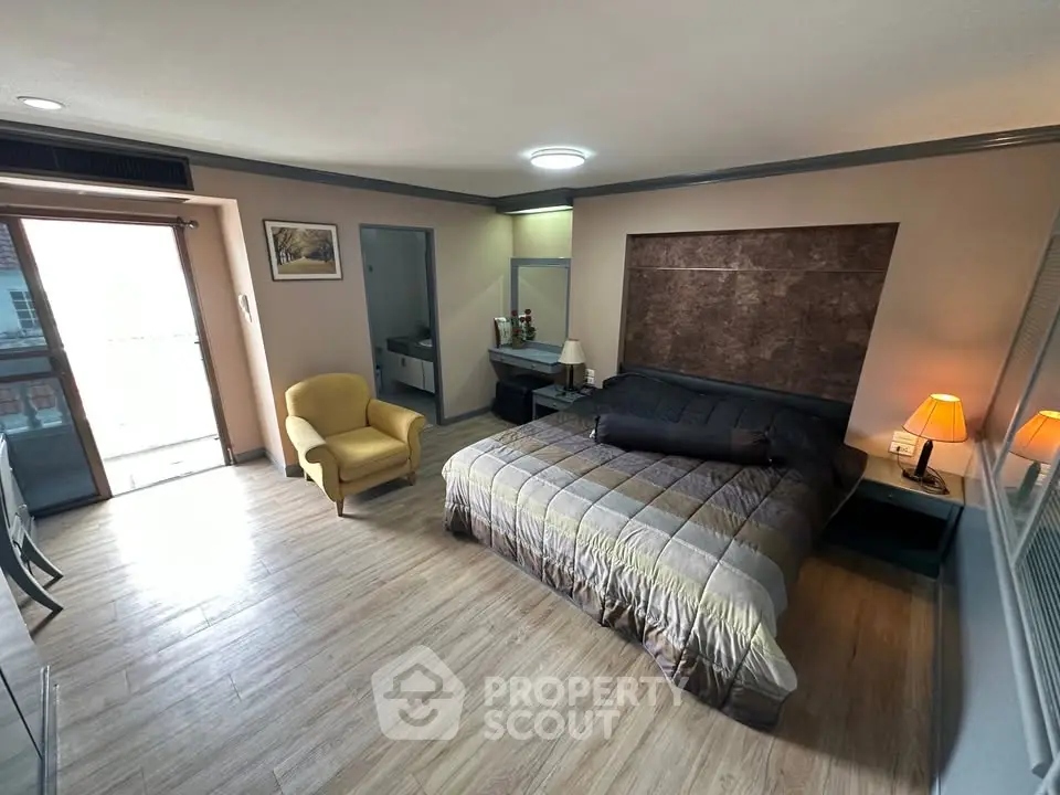 Spacious bedroom with modern decor and balcony access