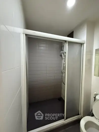 Compact bathroom with sliding shower door and modern fixtures