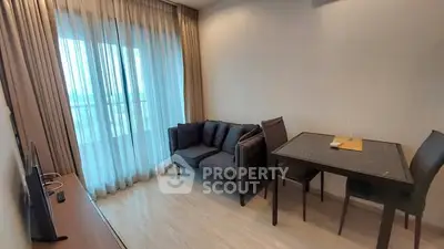 Modern living room with cozy sofa and dining area, featuring floor-to-ceiling windows and elegant curtains.