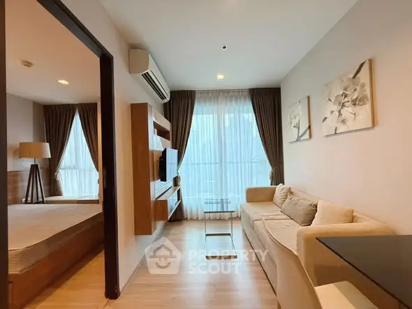 Modern living room with cozy sofa and large window in stylish apartment