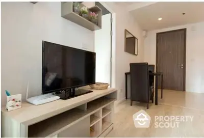 Bright and modern living space with sleek TV stand, ample natural light, and elegant wooden flooring, perfect for urban living.