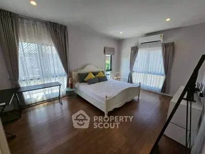 Spacious bedroom with elegant decor and natural light