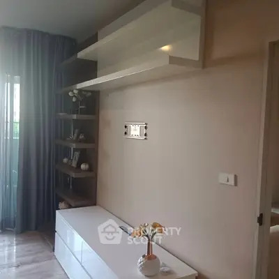 Modern living room with sleek white furniture and elegant shelving