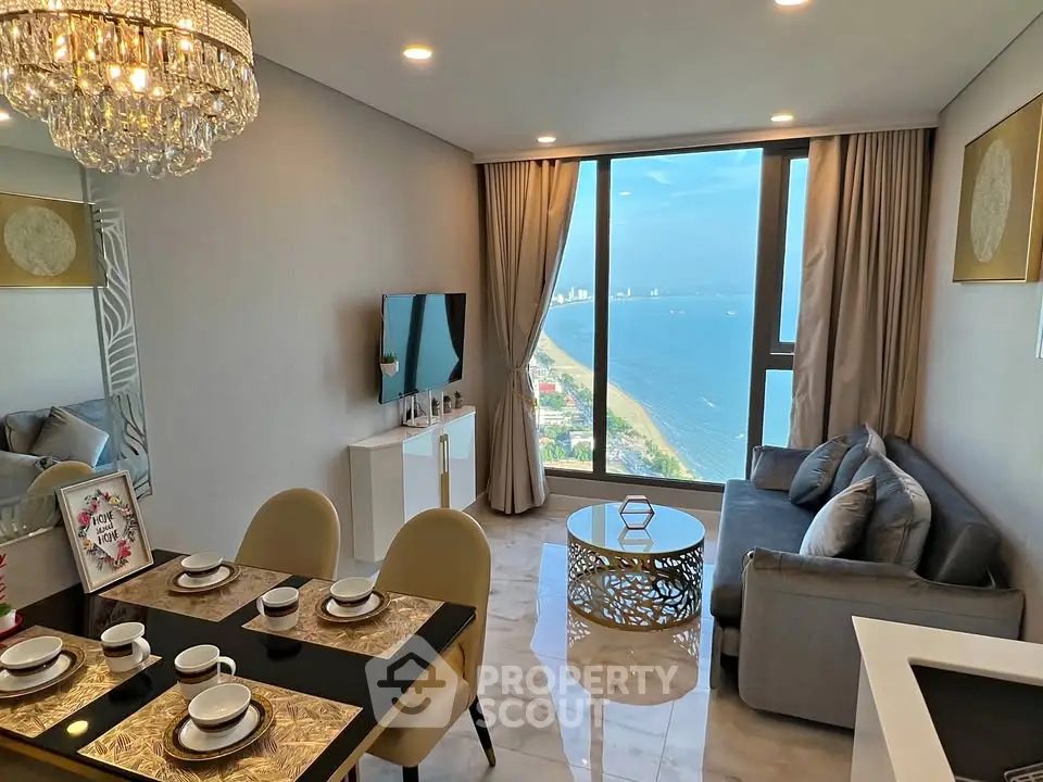 Luxurious living room with ocean view, elegant decor, and modern furnishings in a high-rise apartment.