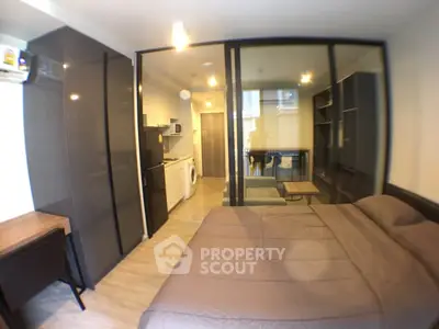 Modern studio apartment with sleek design, featuring a cozy bedroom, compact kitchen, and stylish living area.