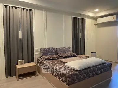 Modern bedroom with stylish decor and cozy ambiance, featuring elegant lighting and sleek furnishings.