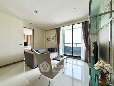 Modern living room with balcony and city view, featuring elegant furniture and natural light.