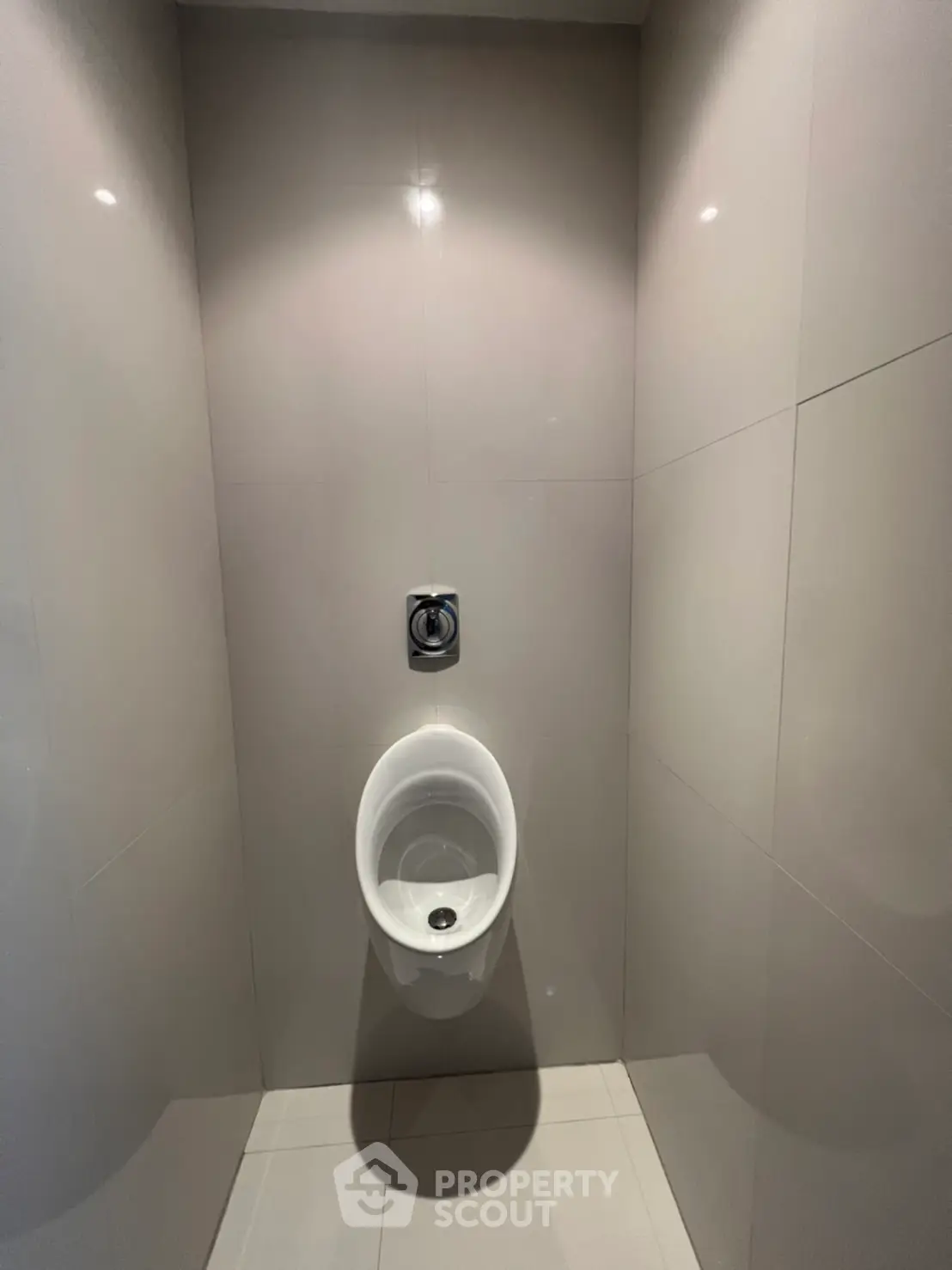Modern bathroom with sleek urinal and minimalist design