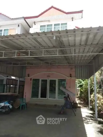 Charming two-story house with covered carport and inviting entrance.