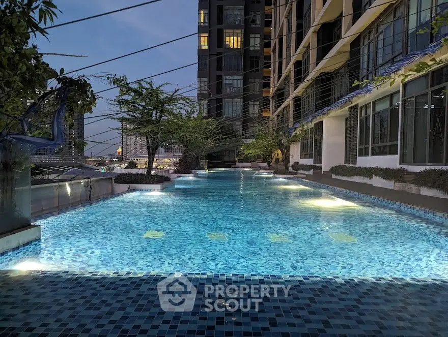 Luxurious rooftop pool with stunning city views at twilight, perfect for relaxation and leisure.