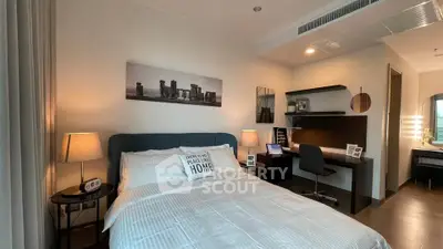 Modern bedroom with cozy bed, stylish desk, and ambient lighting in a contemporary apartment.
