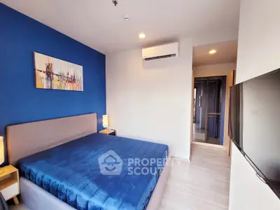 Modern bedroom with blue accent wall and sleek furnishings