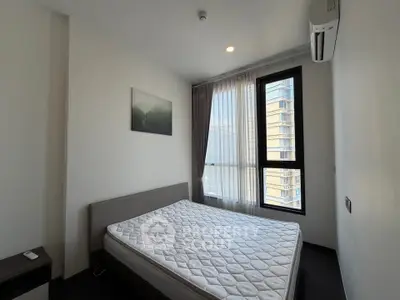 Modern bedroom with large window and air conditioning in a high-rise apartment.