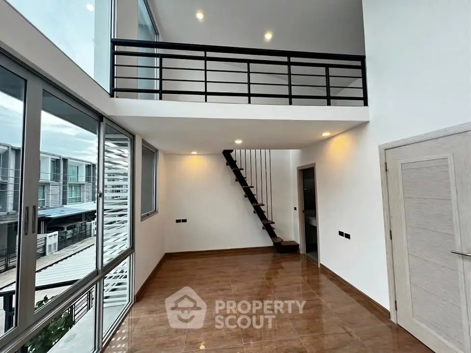 Spacious modern loft with high ceilings and mezzanine in a contemporary apartment.