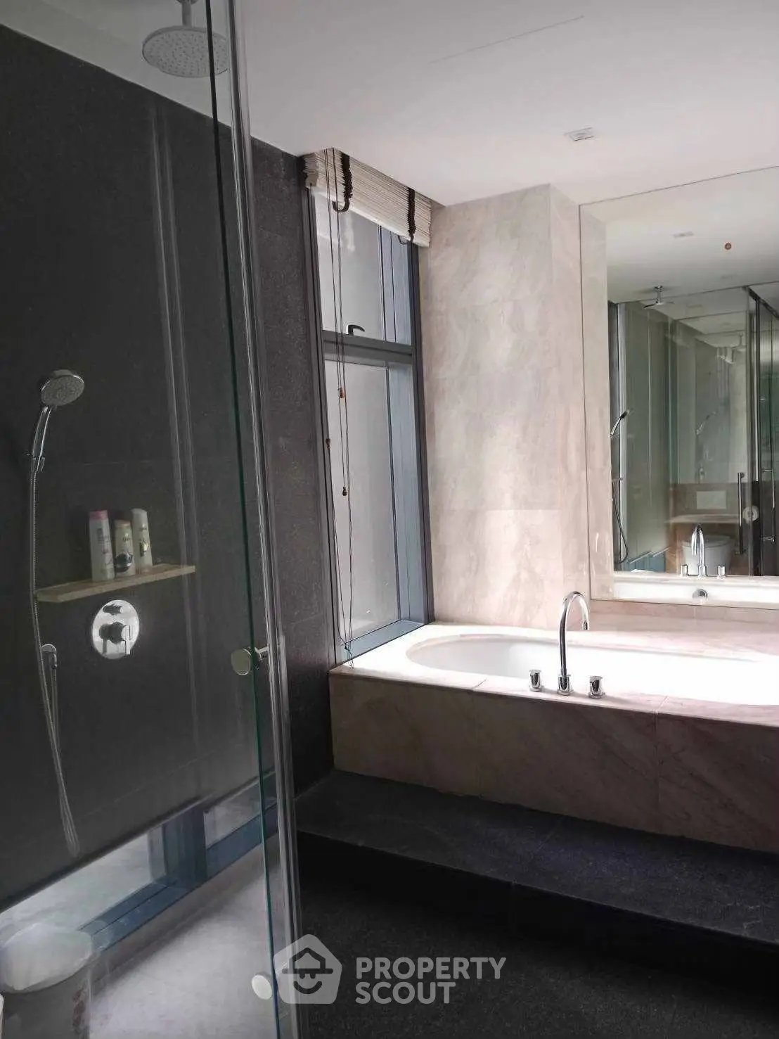 Luxurious bathroom with modern bathtub and glass shower enclosure in elegant design.