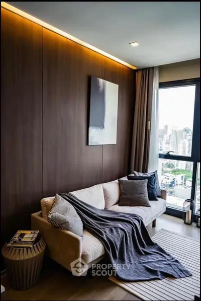 Modern living room with city view, cozy sofa, and stylish decor