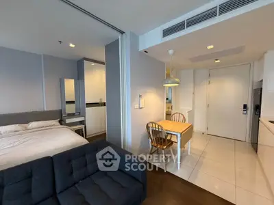 Modern studio apartment with open layout, featuring cozy living area, dining space, and bedroom in a compact design.
