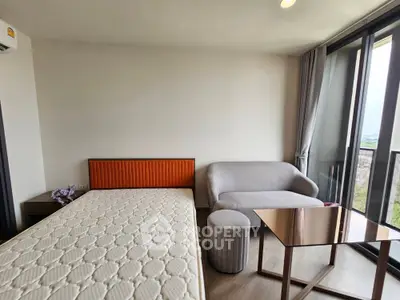 Modern bedroom with large windows and stylish furniture