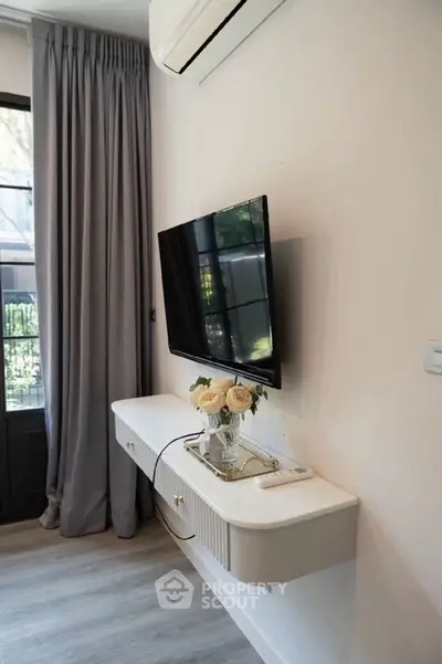 Modern living room with wall-mounted TV and elegant console table