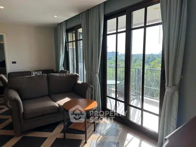 Spacious living room with large windows and balcony view