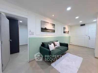 Stylish living room with green sofa and modern decor in a cozy apartment.