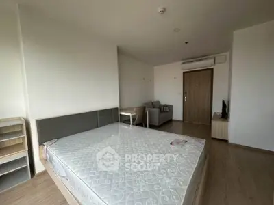 Spacious bedroom with modern furnishings and natural light, perfect for comfortable living.