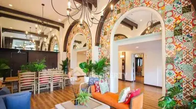 Stunning living room with vibrant tile accents and elegant chandeliers