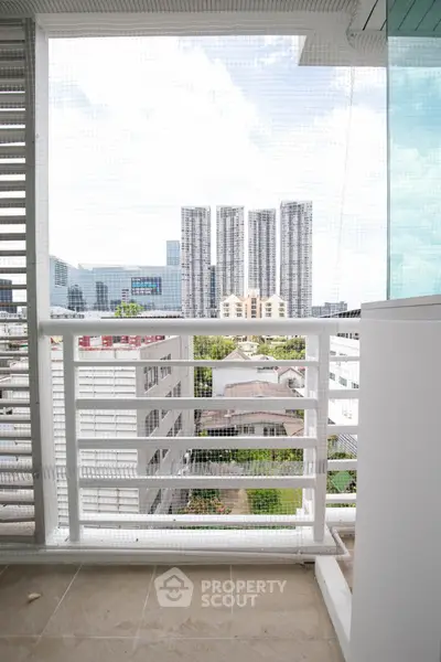 Spacious balcony with city view in modern apartment building