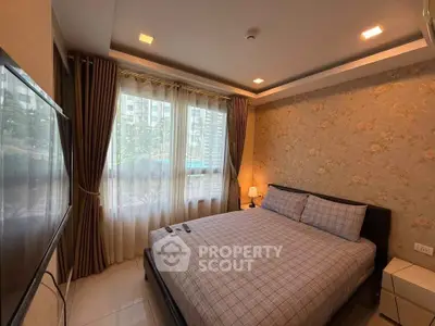 Cozy bedroom with large window and floral wallpaper in modern apartment