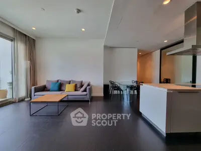 Modern open-plan living room with sleek kitchen and stylish decor