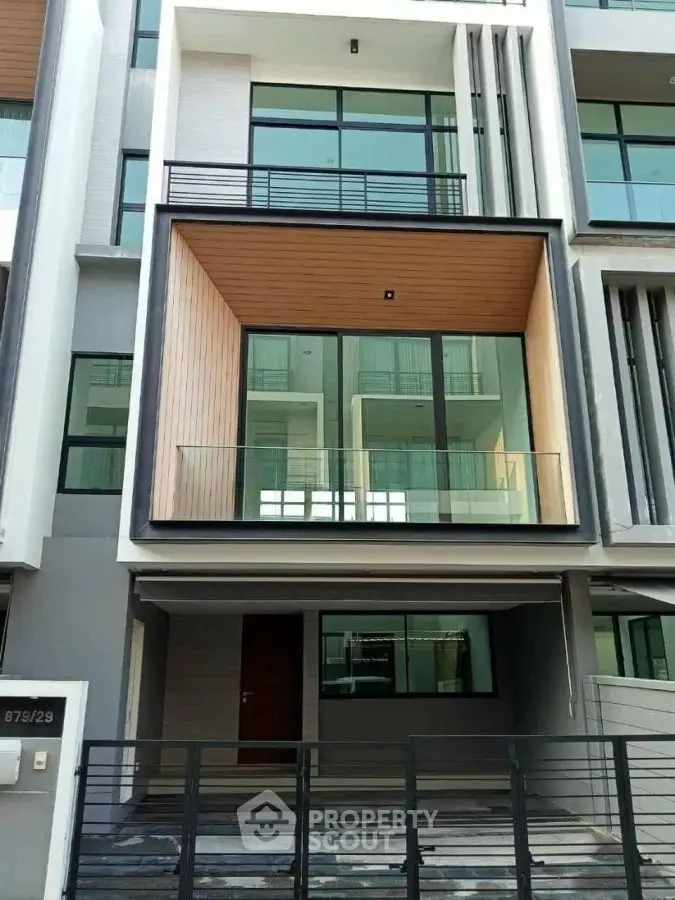 Modern townhouse exterior with sleek design and large windows, perfect for urban living.