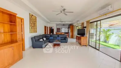 Spacious living room with modern furniture and sliding glass doors to garden