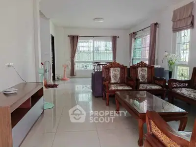 Spacious living room with elegant wooden furniture and large windows