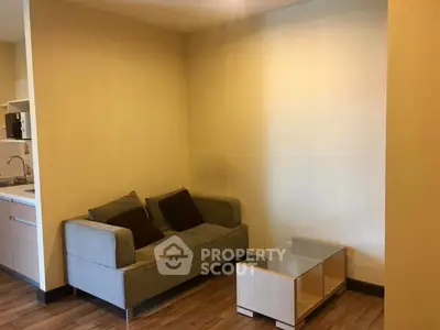 Cozy living room with modern sofa and glass coffee table in a stylish apartment.