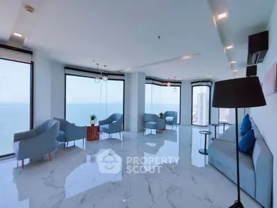 Luxurious living room with panoramic ocean views and modern furnishings.