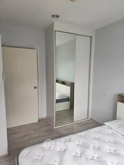 Modern bedroom with mirrored wardrobe and minimalist design