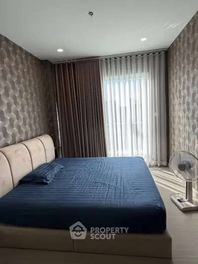 Modern bedroom with stylish wallpaper and natural light