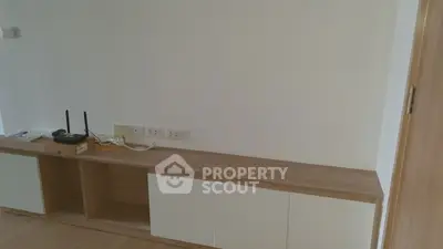 Minimalist living room with wooden cabinet and modern router setup.