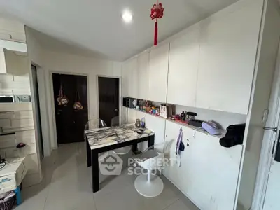 Modern kitchen with marble table and sleek cabinetry, perfect for stylish urban living.