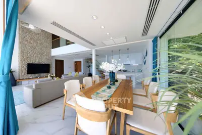 Luxurious open-plan living and dining area with modern decor and natural light