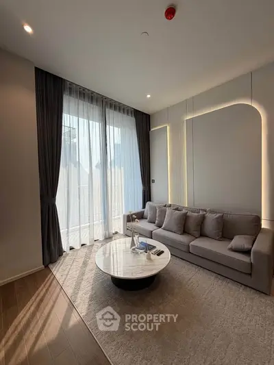 Modern living room with elegant sofa and floor-to-ceiling windows