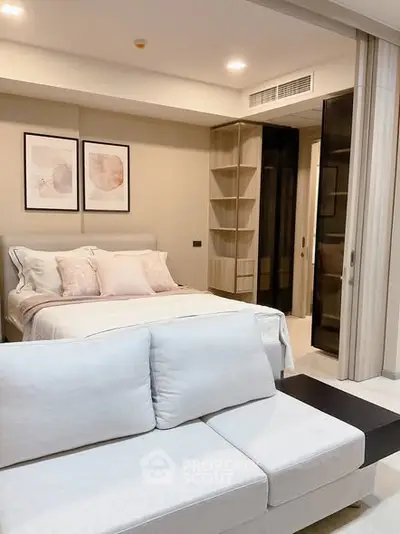 Modern bedroom with stylish decor and cozy seating area in a contemporary apartment.