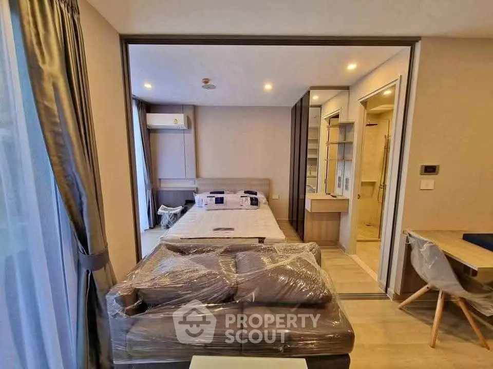 Modern studio apartment with cozy bedroom and stylish furnishings, perfect for urban living.